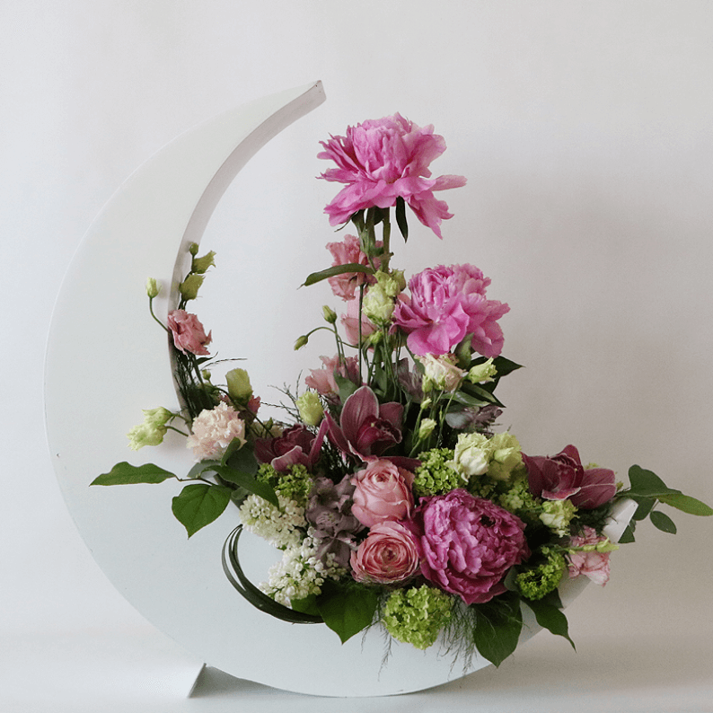 pink peonies, pink flowers, and green in a white crescent moon