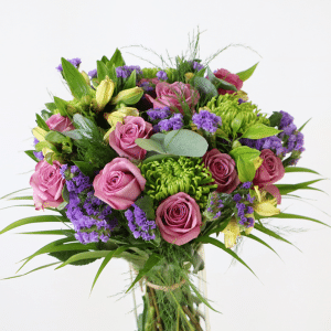 Purple roses with statice and chrysanthemums in a bouquet