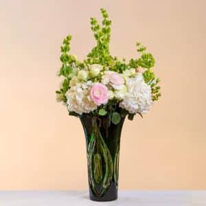 Green crystal vase with flowers