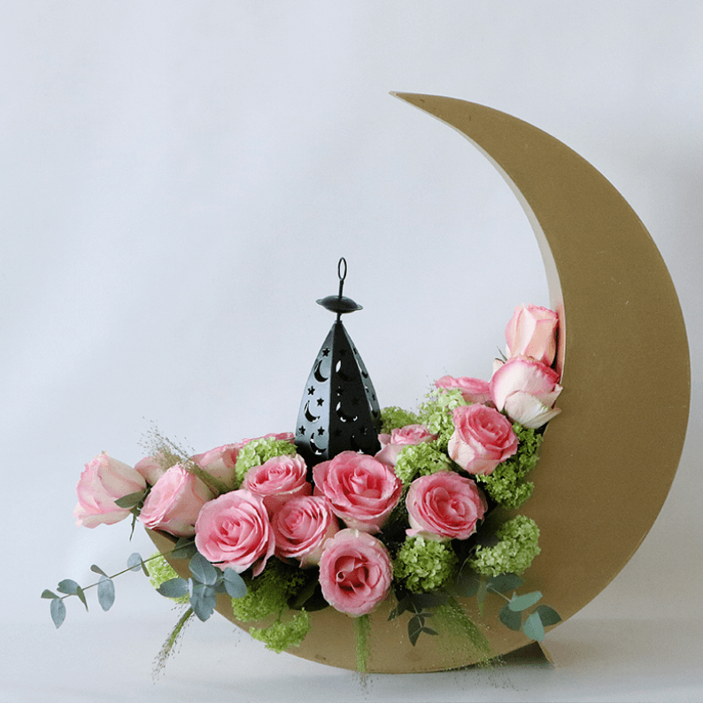 pink roses in a gold crescent moon with a lantern