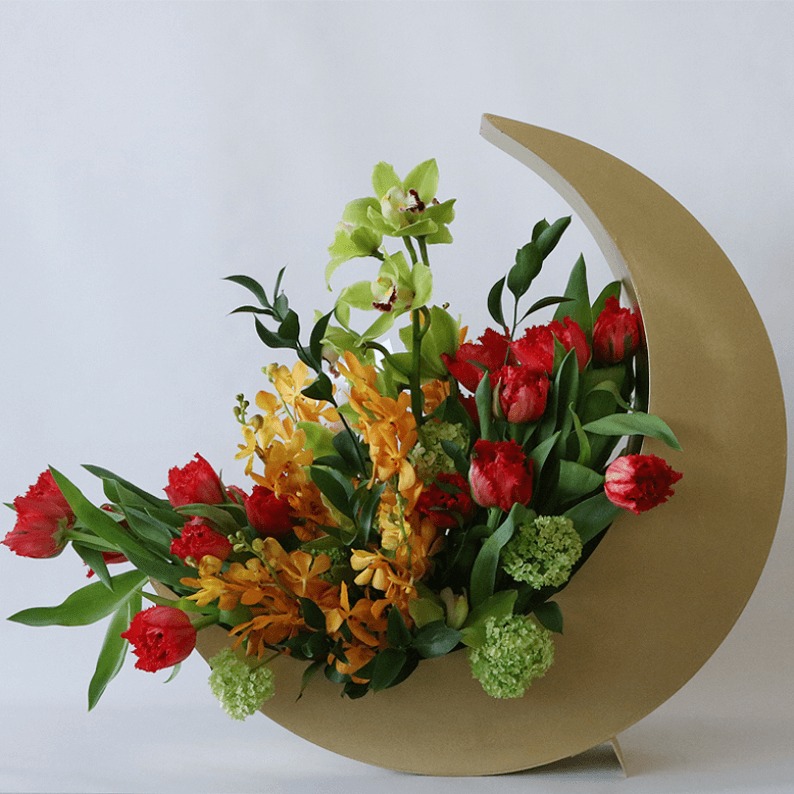 red tulips nad orchids in a gold crescent moon