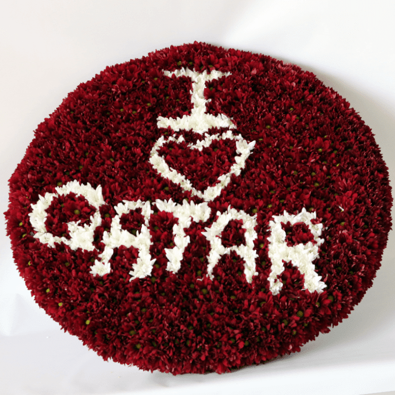 Chrysanthemums maroon and white with I love Qatar written in flowers