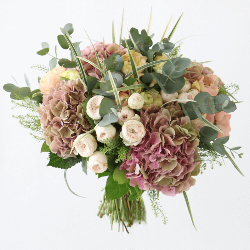 pink and green hydrangeas, spray roses and eucalyptus in a bouquet