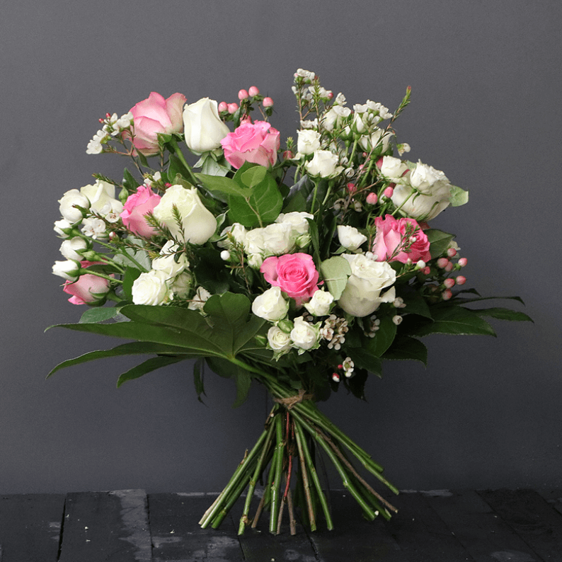 pink and white bouquet with roses, spray roses and wax flower