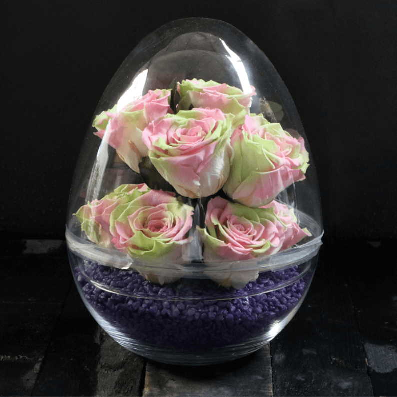 green and pink roses with purple stones in a dome