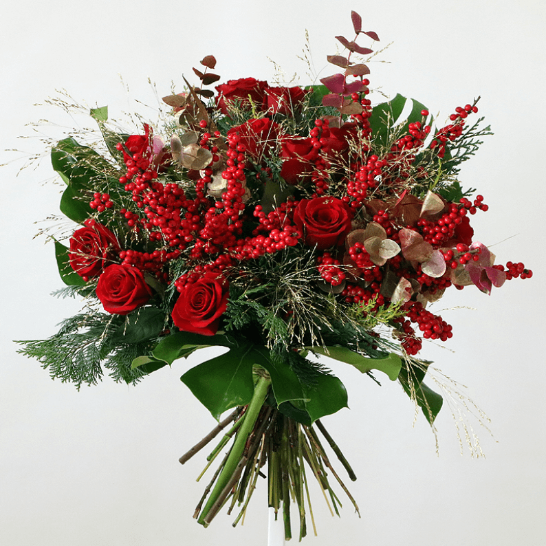 Red rose, red berries and natural greenery