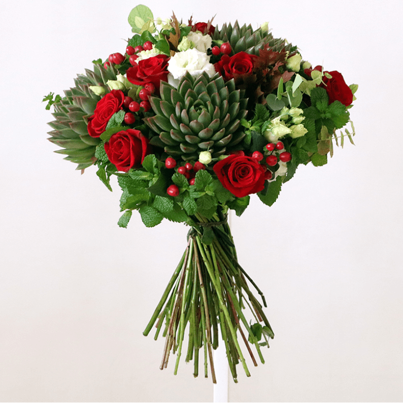red rose, red hypericum, mint, succulents and white eustoma in a bouquet