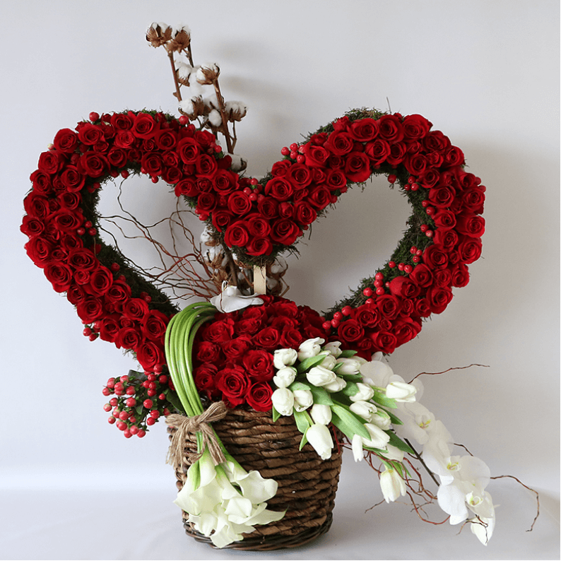 huge heart made from red roses and tulips in a basket with calla lilys