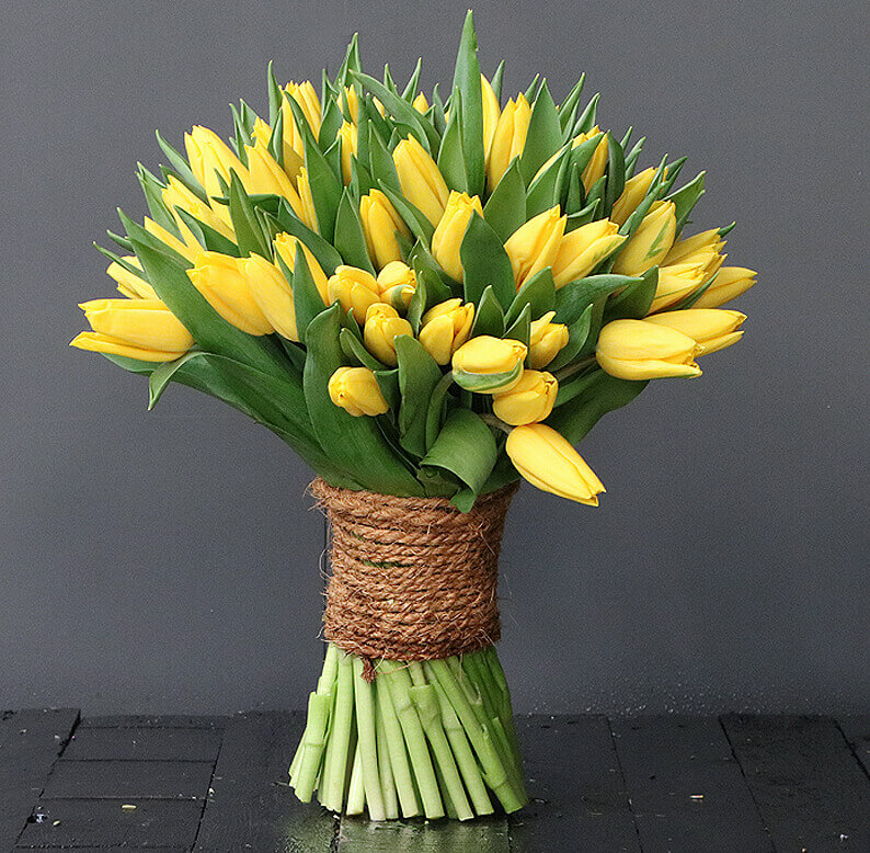 yellow tulips wrapped in rope