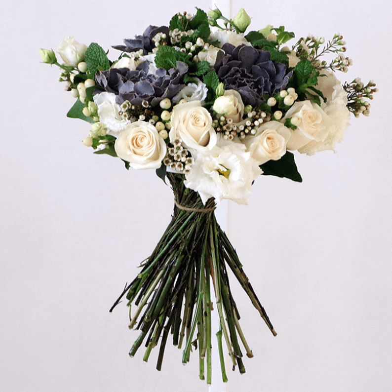 white rose, mint, eustoma and wax flower in a bouquet