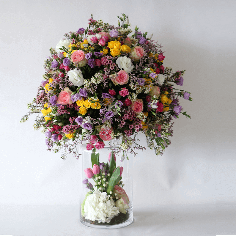 mixture of spring flowers in a tall vase