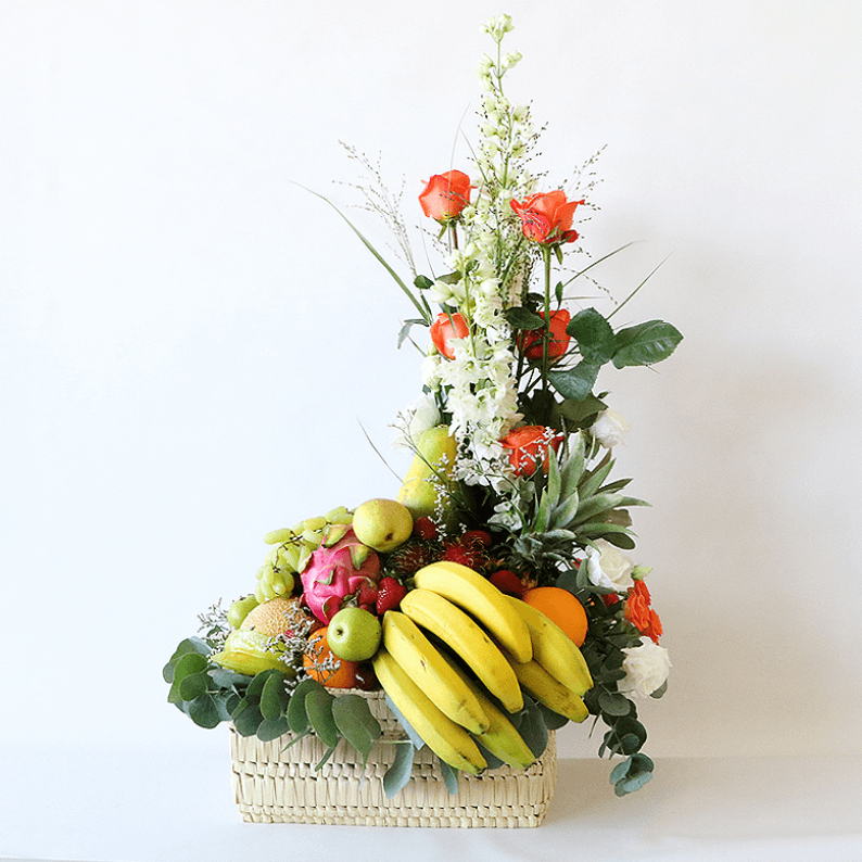 tropical fruit in a basket with flowers