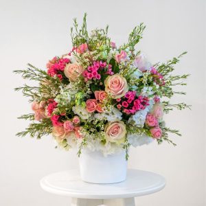 pink spray roses, white eustoma, wax flower, pink large headed roses and pink bouvadia