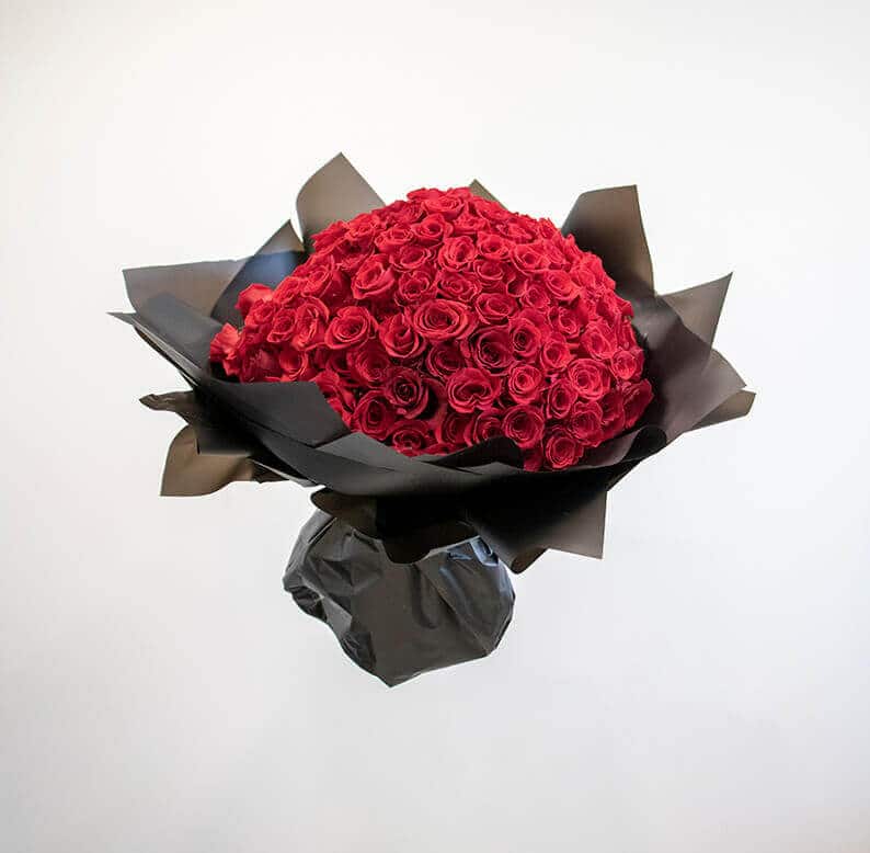 150 red roses wrapped in black paper