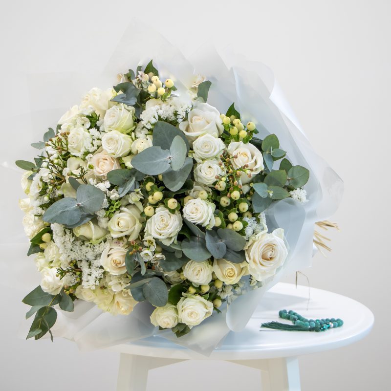 white and green bouquet with prayer beads