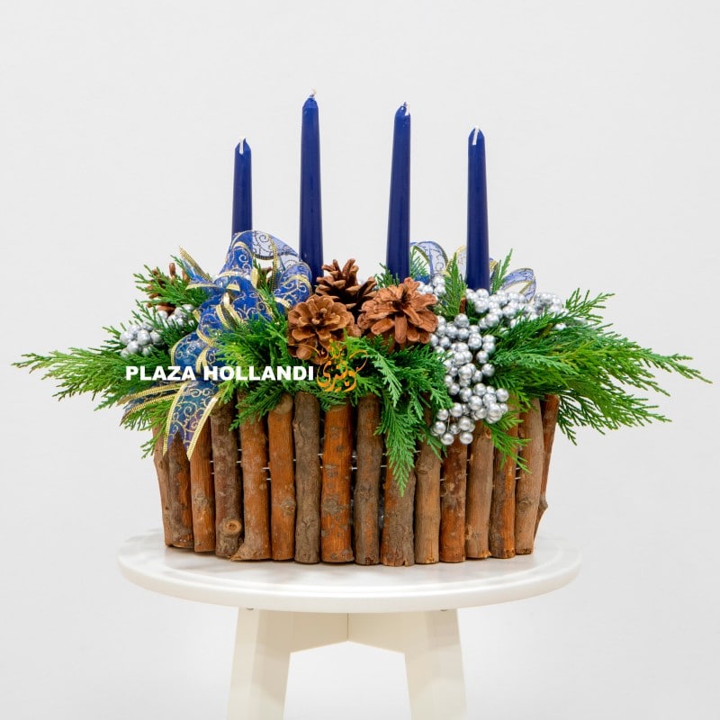 A green advent arrangement with four candles.