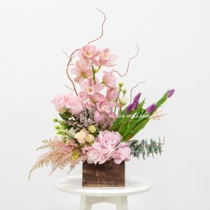 Unique arrangement of pink flowers in a box