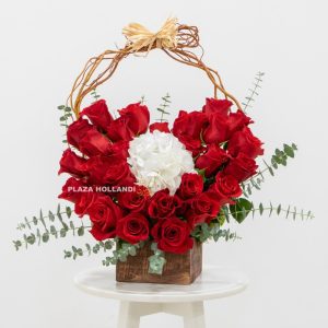 red heart design in red roses in a brown box