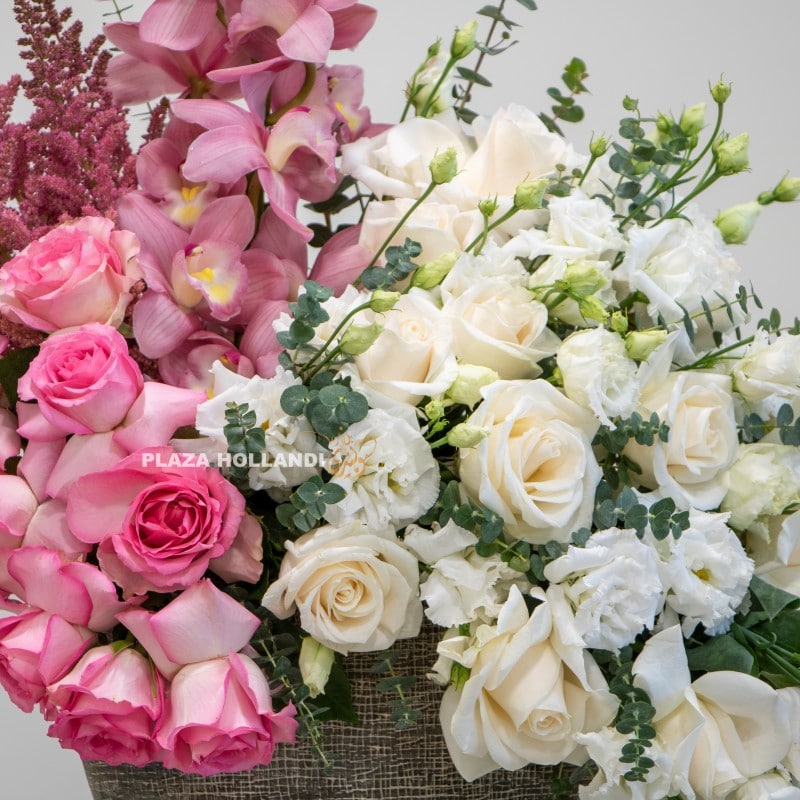 close up of white roses, pink roses and cymbidium orchids
