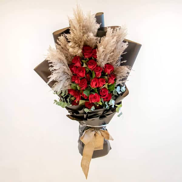 Red roses with eucalyptus and pampas grass
