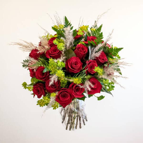 Red roses, pampas grass in a bouquet