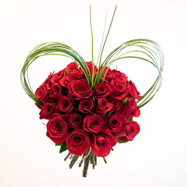 Red roses bouquet with steel grass