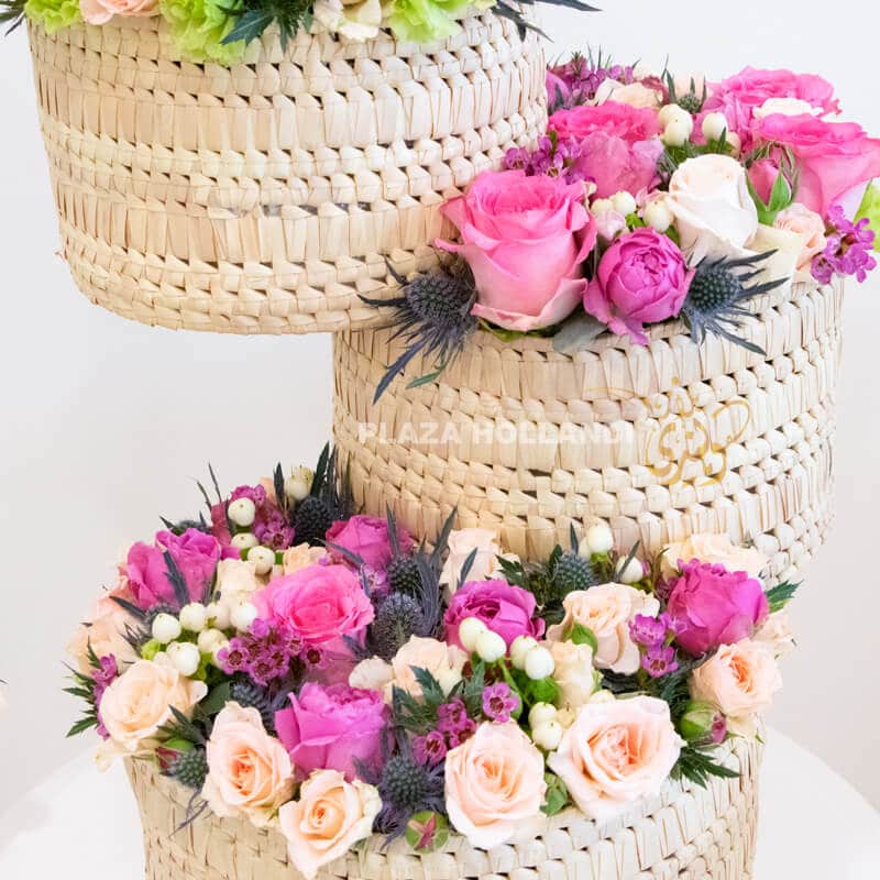 Close up of three baskets with pink and white flowers