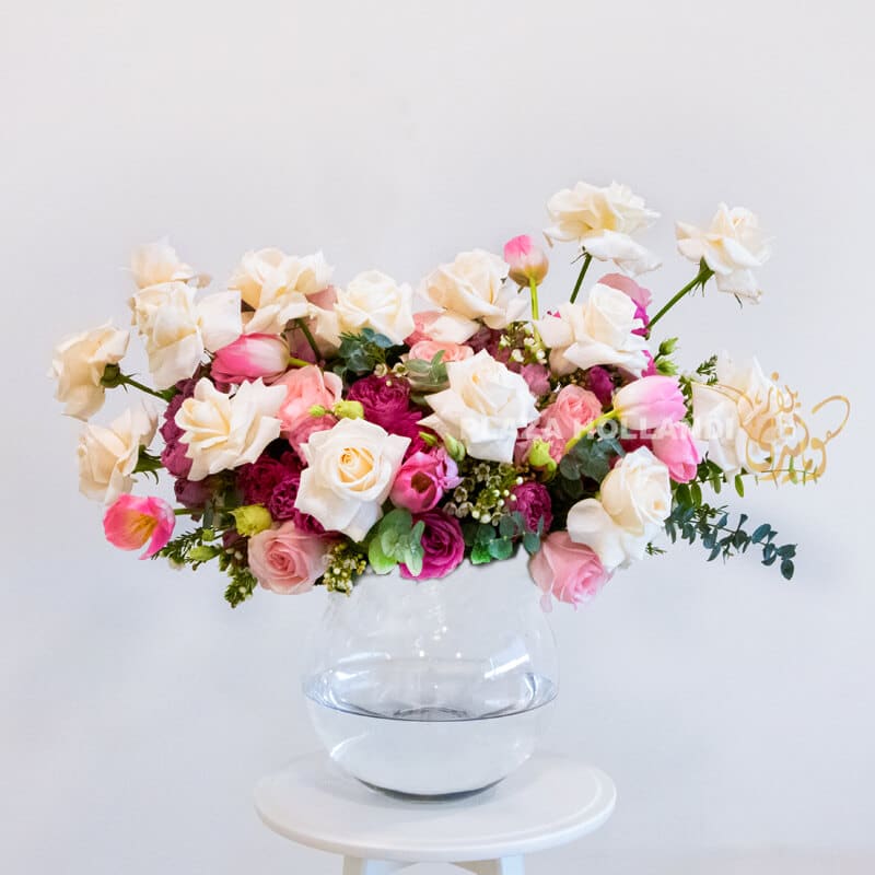 Pink cream andpurple flower arrangement in a glass vase