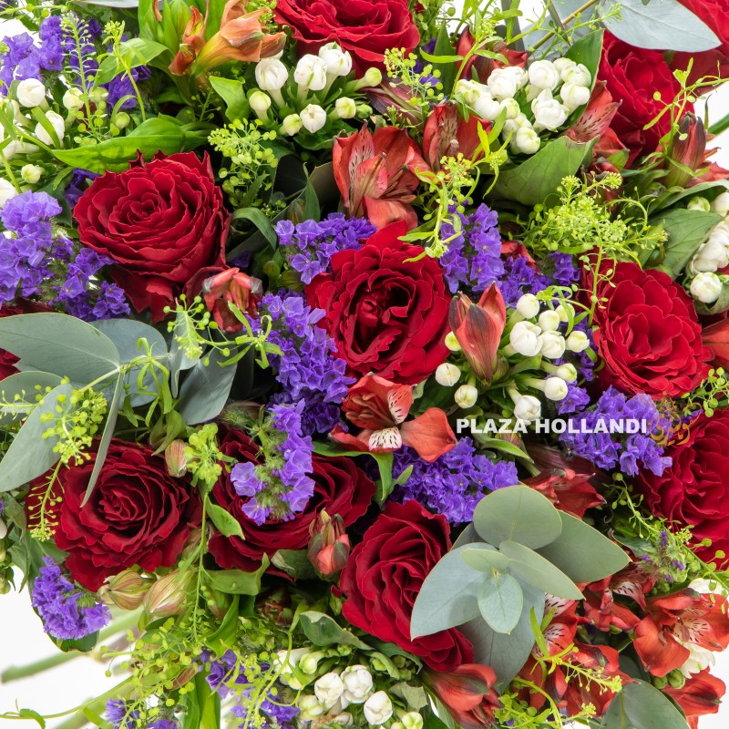 close up of red rose, purple statice flower bouquet