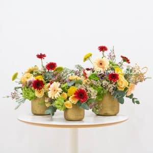 three gold pots with flowers