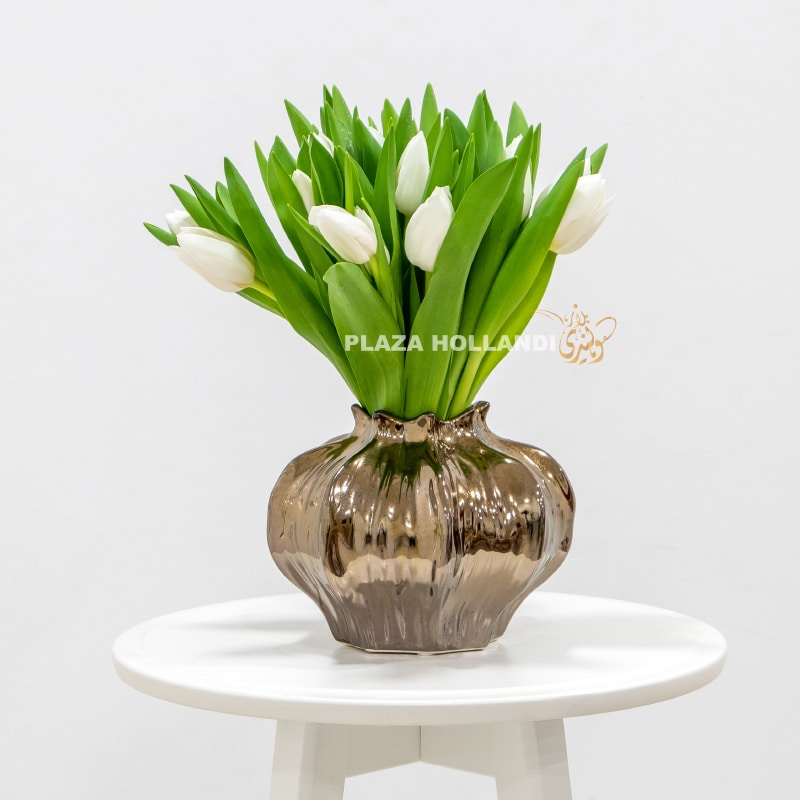 white tulips in a brass vase