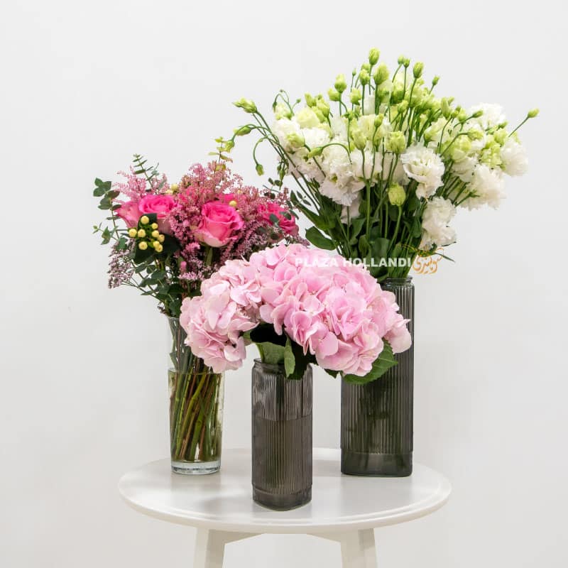 Three vases full of pink and white flowers