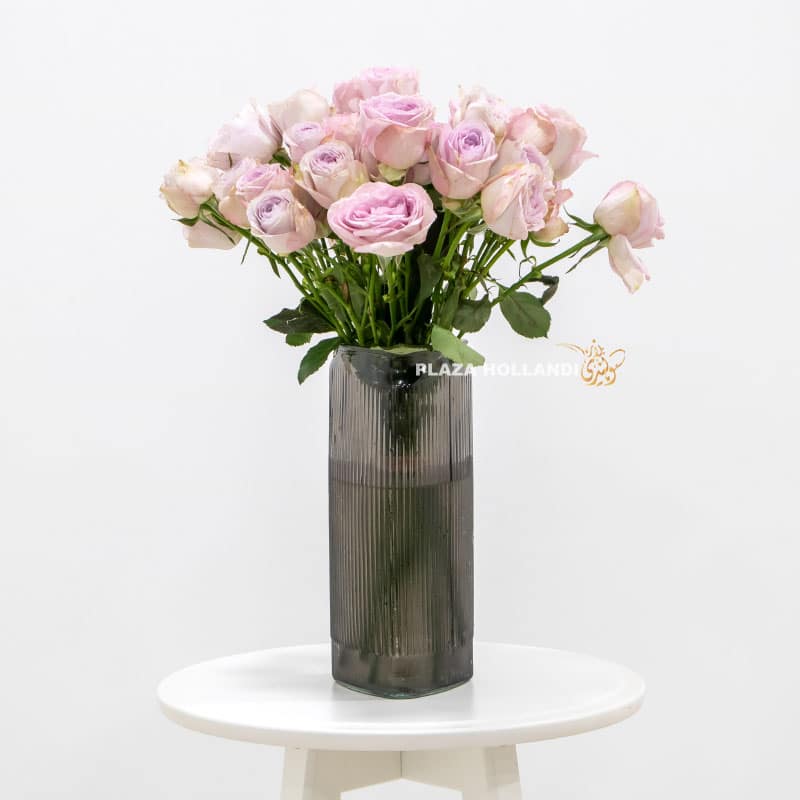 Purple spray roses in a black vase