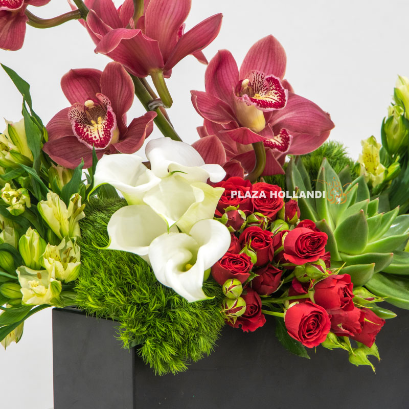 close up of Black box filled with orchids, eustoma, spray rose and calla lily flowers