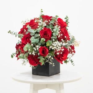 Red and white flower arrangement in a black box