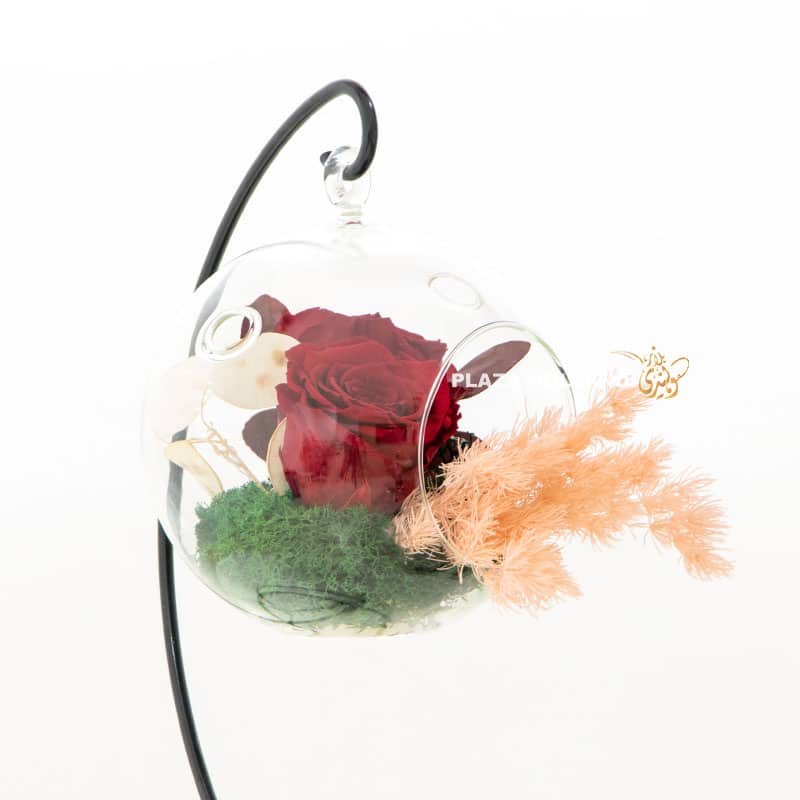 Red preserved rose with dried foliage