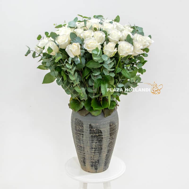 Luxurious pot with white roses and eucalyptus