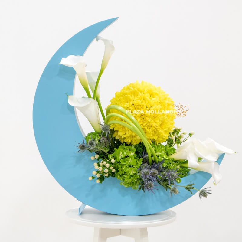 Blue crescent moon with yellow and white flowers