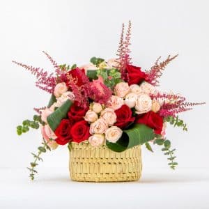 flower arrangement with roses in a basket