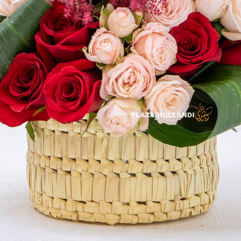 close up of basket and flower arrangement with roses