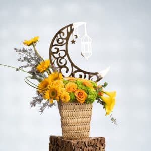 60 cm Yellow Roses, Sunflowers, Yellow Calla Lily, and Green Hydrangea arranged in a stylish reed basket for a fresh and cheerful floral display.